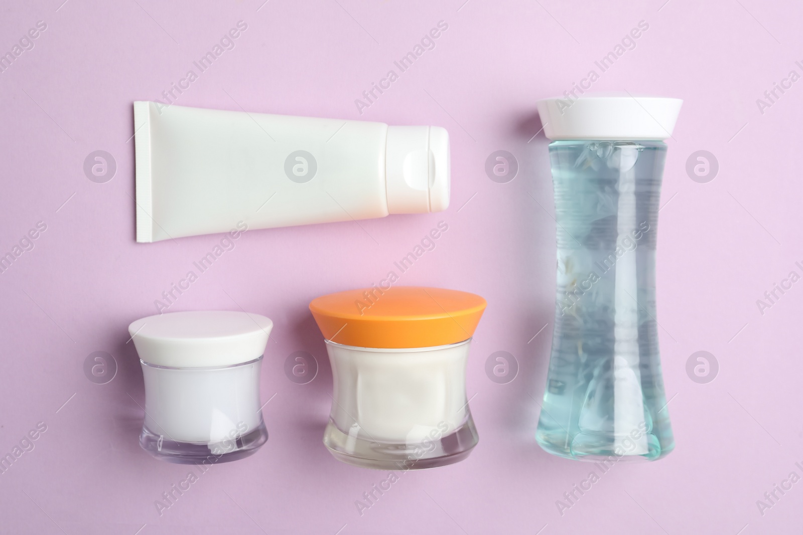Photo of Set of luxury cosmetic products on violet background, flat lay
