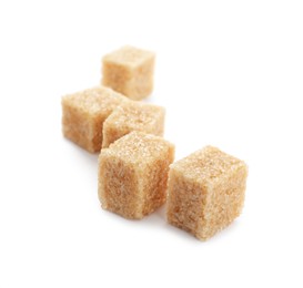 Photo of Cubes of brown sugar isolated on white