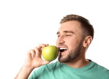 Photo of Young man with healthy teeth and apple on white background