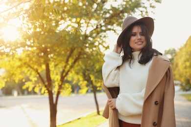 Photo of Beautiful young woman wearing stylish clothes in autumn park