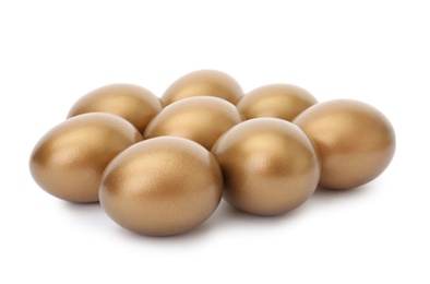 Many shiny golden eggs on white background