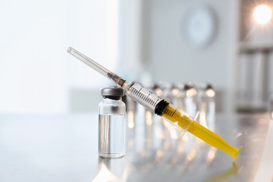 Syringe with vial of medicine on table