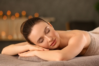 Beautiful young woman relaxing in spa salon