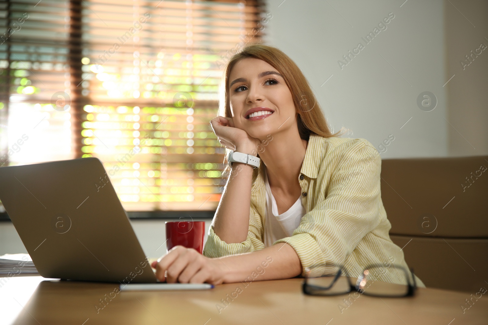 Photo of Young woman relaxing at desk in office