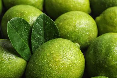 Photo of Fresh ripe juicy limes as background, closeup