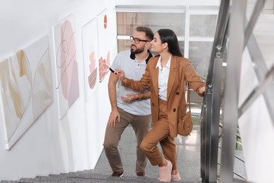 Photo of Happy couple at exhibition in art gallery