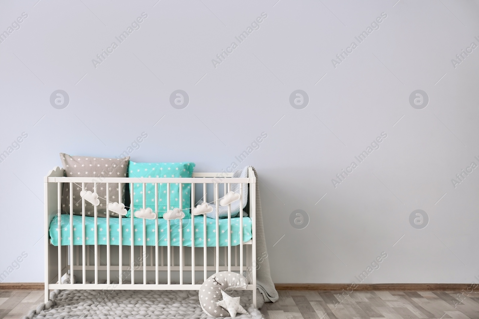 Photo of Baby room interior with crib near wall