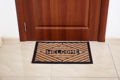 Photo of Brown welcome doormat at door in hall