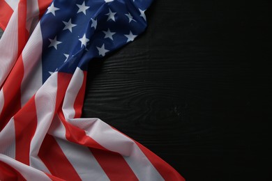 Photo of Flag of USA on black wooden table, top view. Space for text