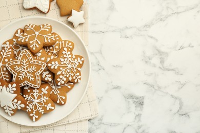 Tasty star shaped Christmas cookies with icing on white marble table, top view. Space for text