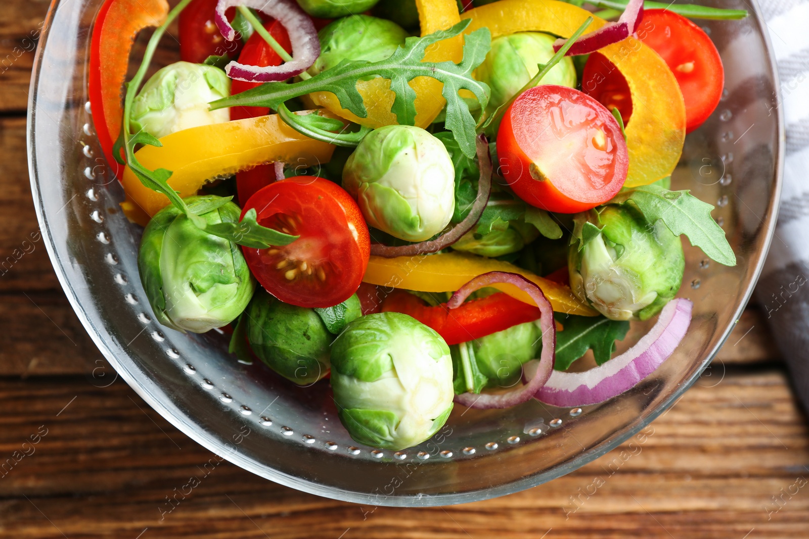 Photo of Tasty salad with Brussels sprouts on wooden table, flat lay