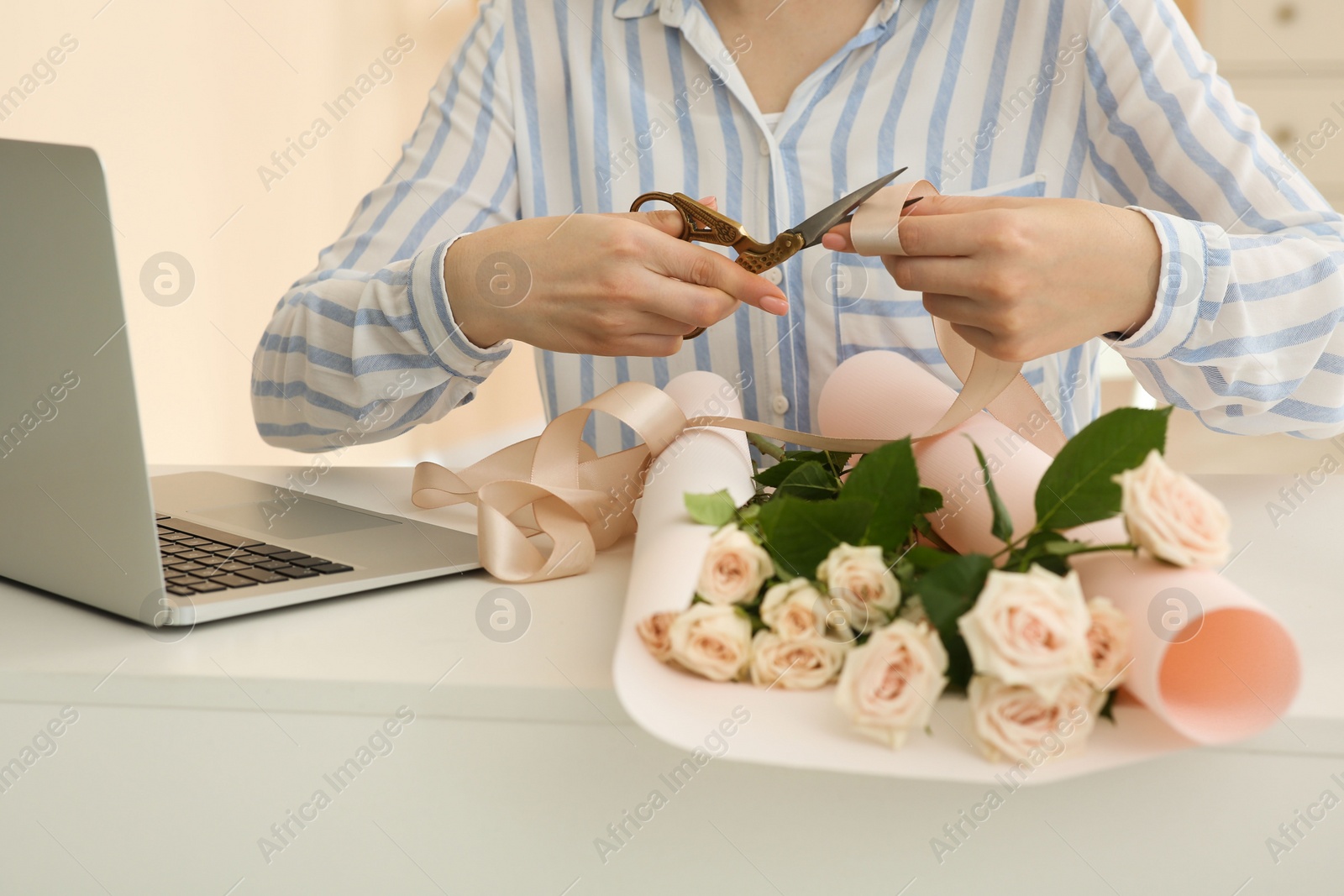 Photo of Woman making bouquet following online florist course at home, closeup. Time for hobby