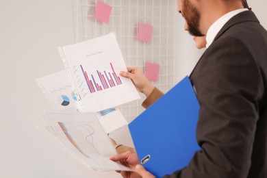 Businesspeople working with charts in office, closeup
