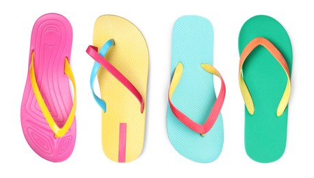 Set with different colorful flip flops on white background, top view 