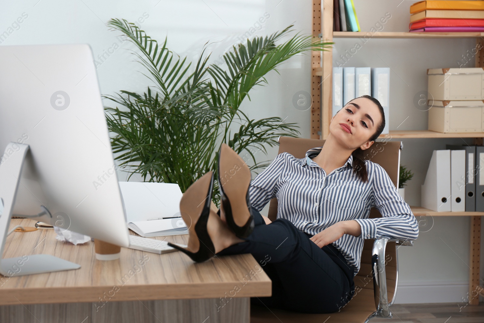 Photo of Lazy employee sleeping at table in office