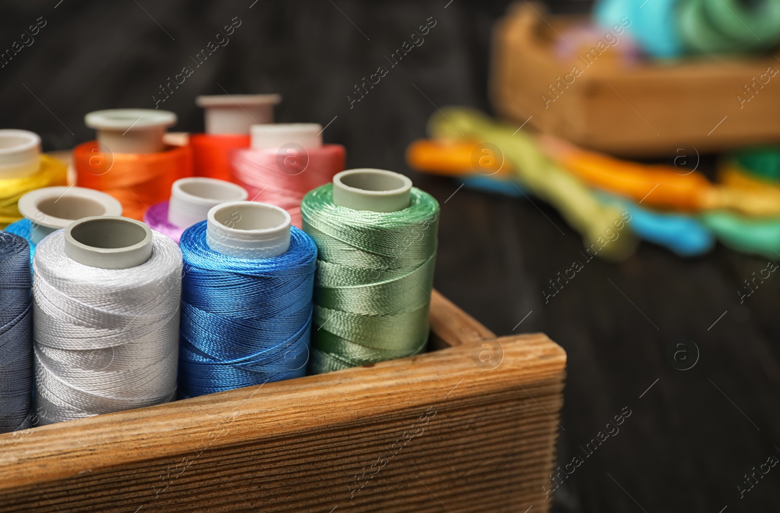 Photo of Drawer with color sewing threads, closeup
