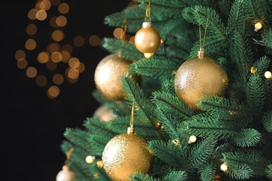 Beautiful Christmas tree with festive decor against blurred lights on background