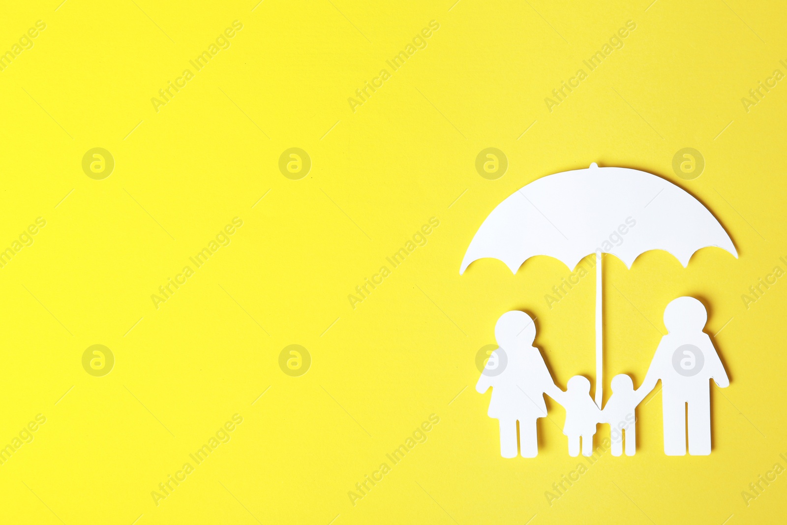 Photo of Paper silhouette of family under umbrella and space for text on color background, top view. Life insurance concept