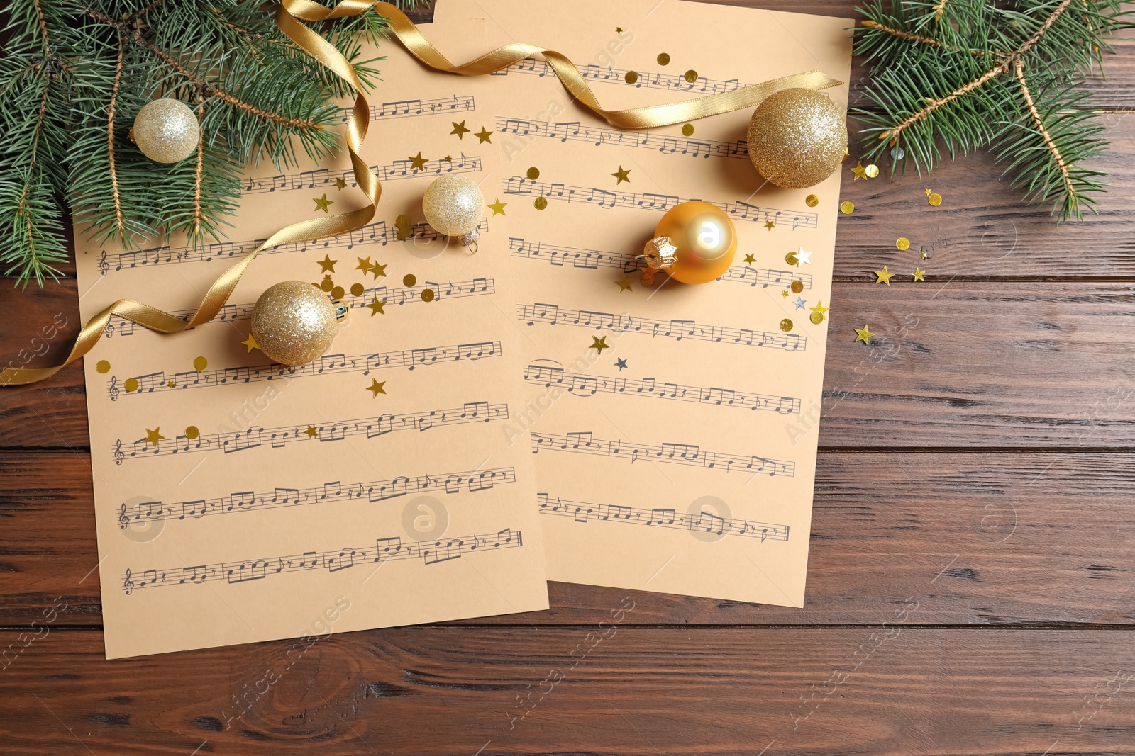 Photo of Flat lay composition with Christmas decorations and music sheets on wooden background