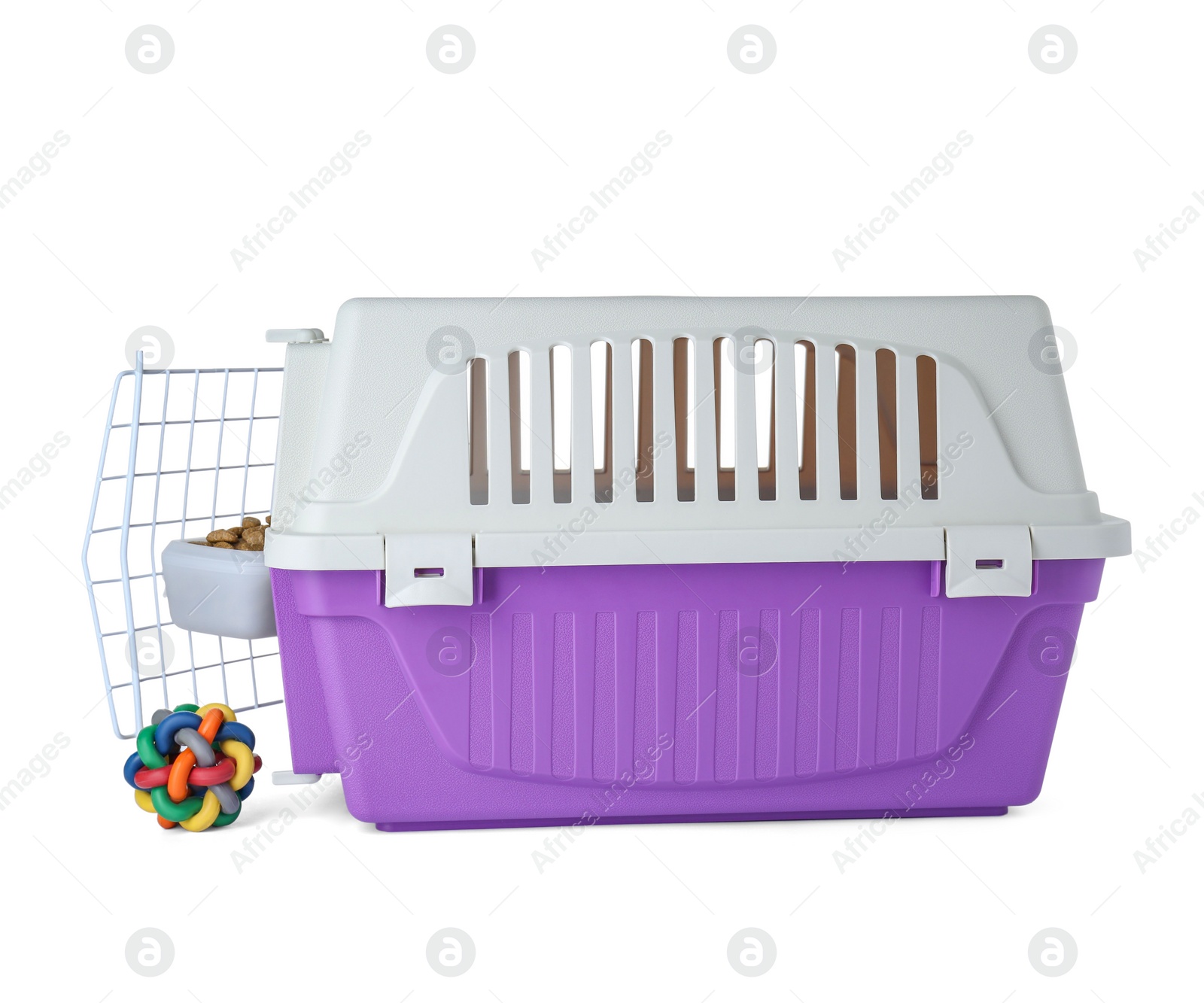 Photo of Violet pet carrier with bowl of dry food and toy isolated on white