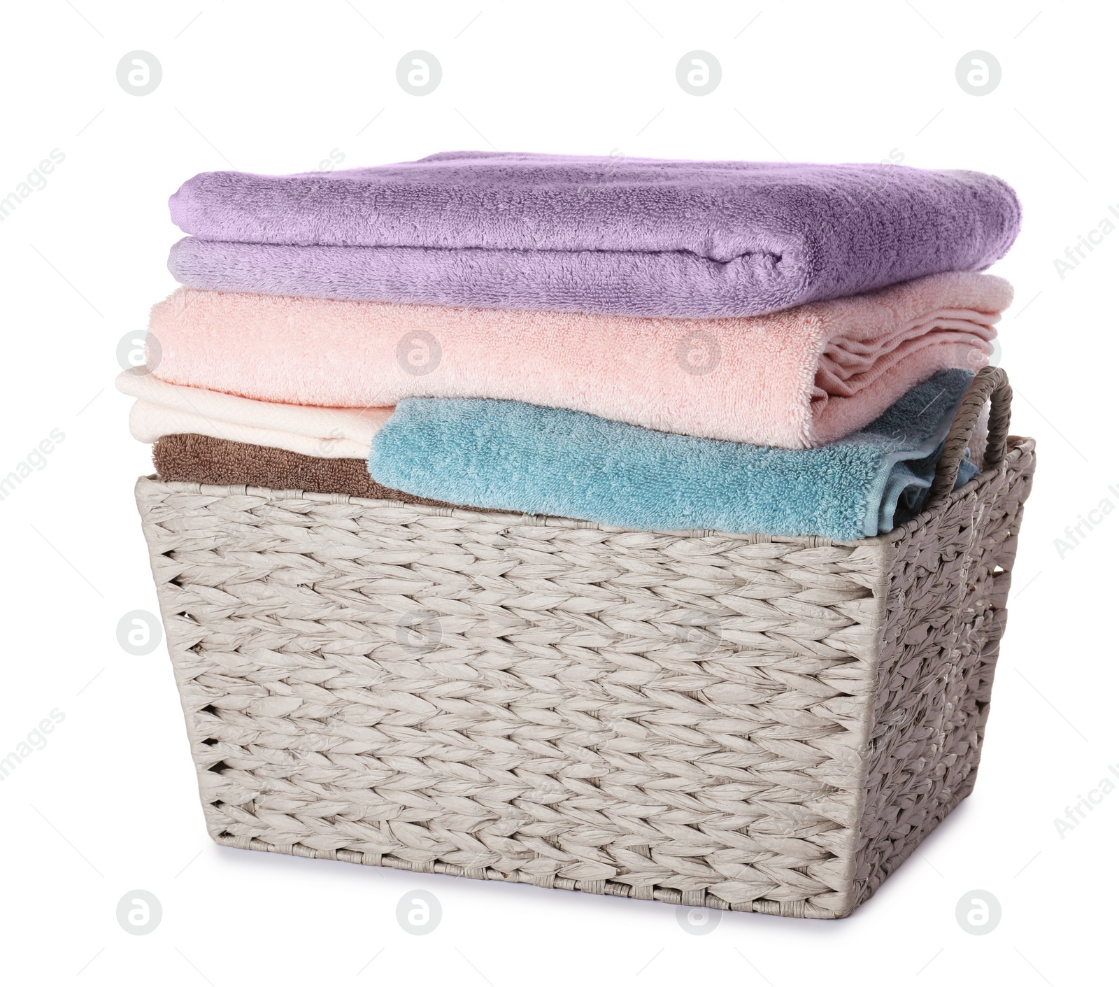 Photo of Wicker laundry basket with clean towels on white background