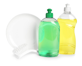 Detergents, brush and plate on white background. Clean dishes