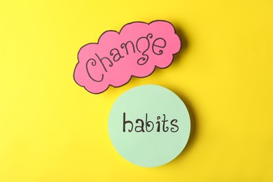 Photo of Phrase Change Habits on yellow background, flat lay