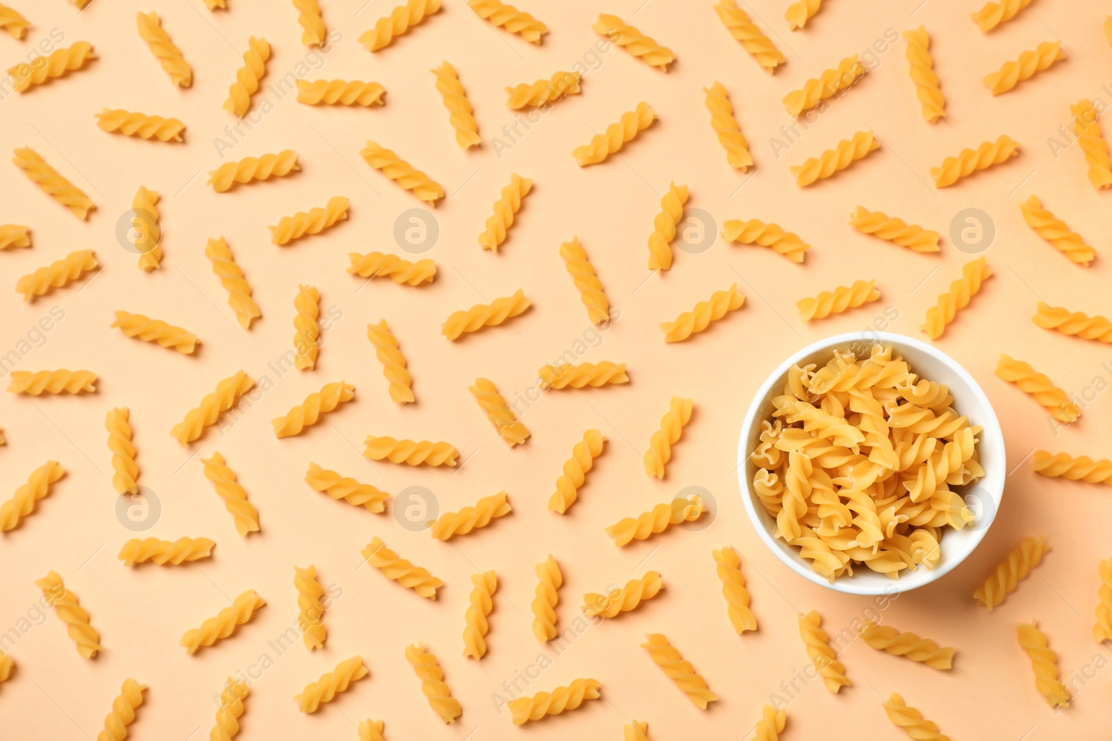 Photo of Beautiful composition with raw pasta on color background