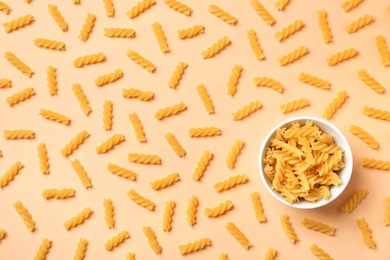 Beautiful composition with raw pasta on color background