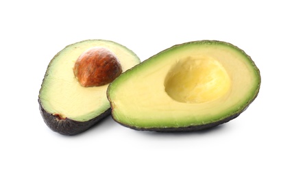 Photo of Cut ripe avocado with pit on white background