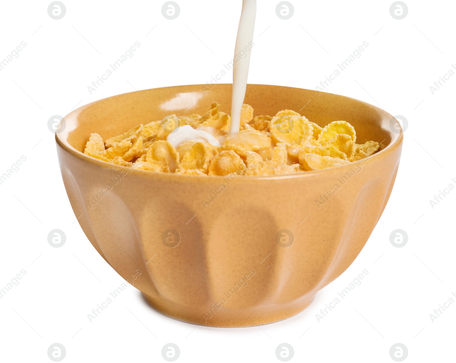 Photo of Milk pouring into bowl with crispy cornflakes on white background