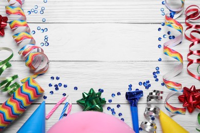 Photo of Flat lay composition with party items on white wooden table, space for text. Birthday celebration