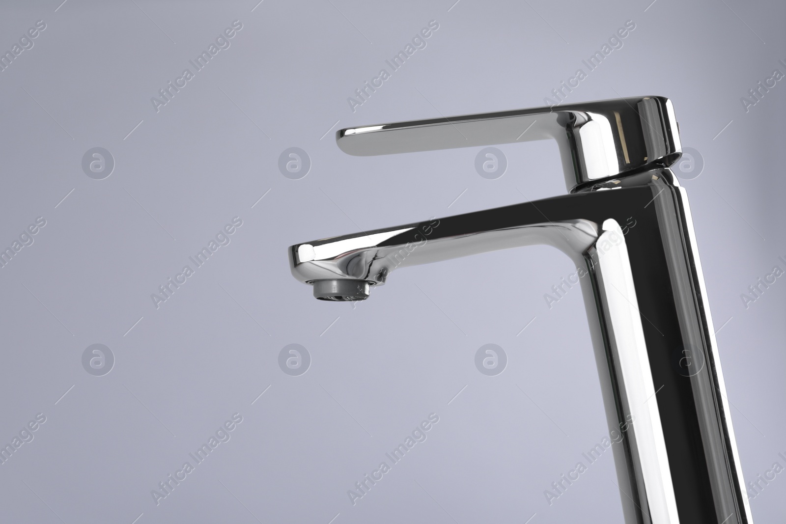 Photo of Single handle water tap on grey background. Space for text