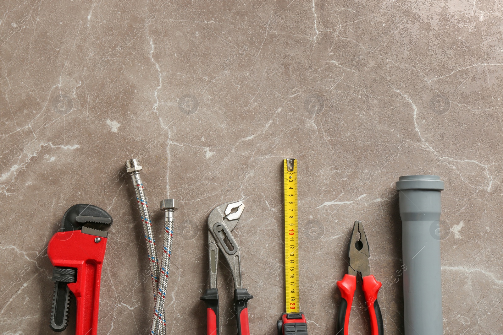 Photo of Flat lay composition with plumber's tools and space for text on grunge background