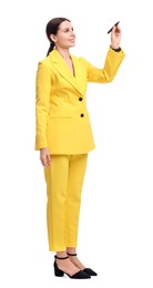 Photo of Beautiful businesswoman in yellow suit with marker on white background