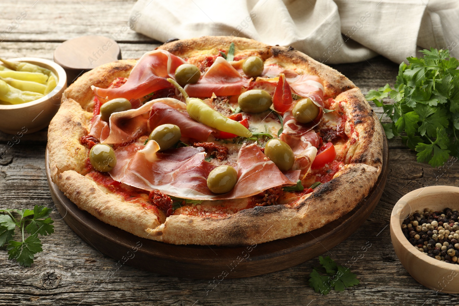 Photo of Tasty pizza and ingredients on wooden table