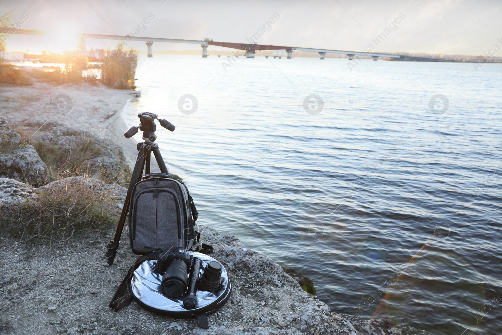 Photo of Professional photography equipment on rocky river coast