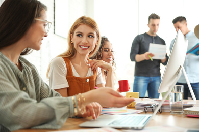 Photo of Team of professional designers working in office