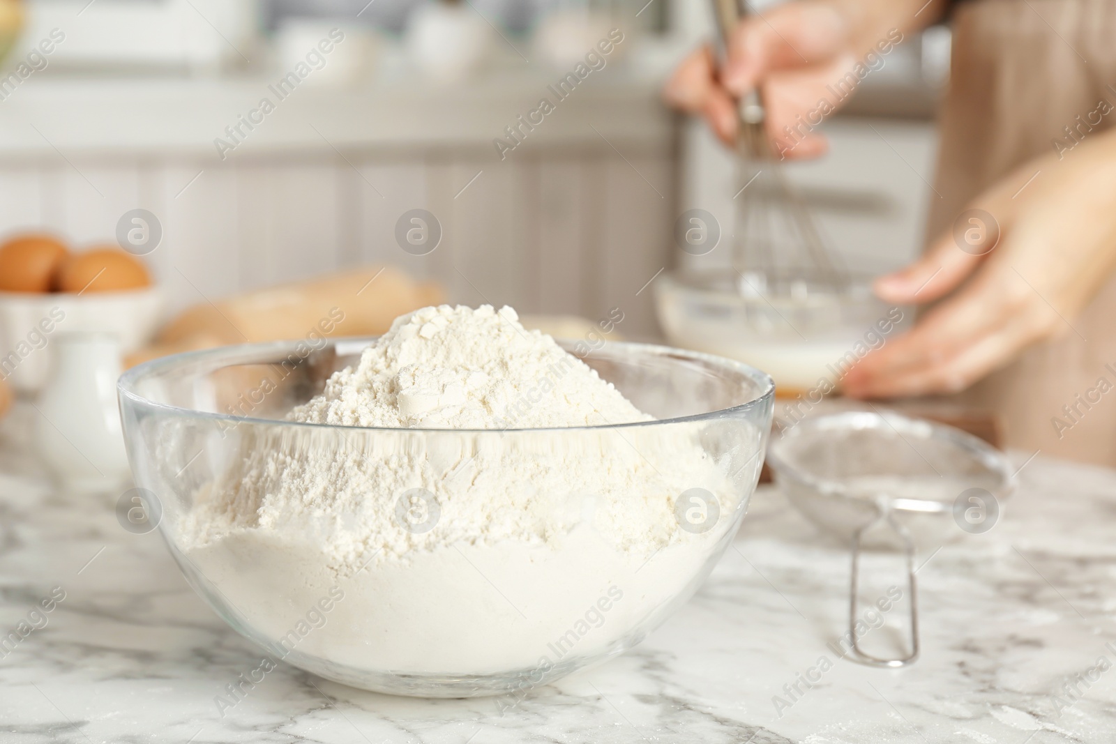 Photo of Bowl with flour and woman on background