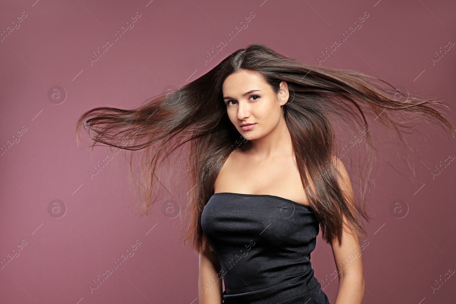 Photo of Portrait of beautiful model with gorgeous straight hair on color background