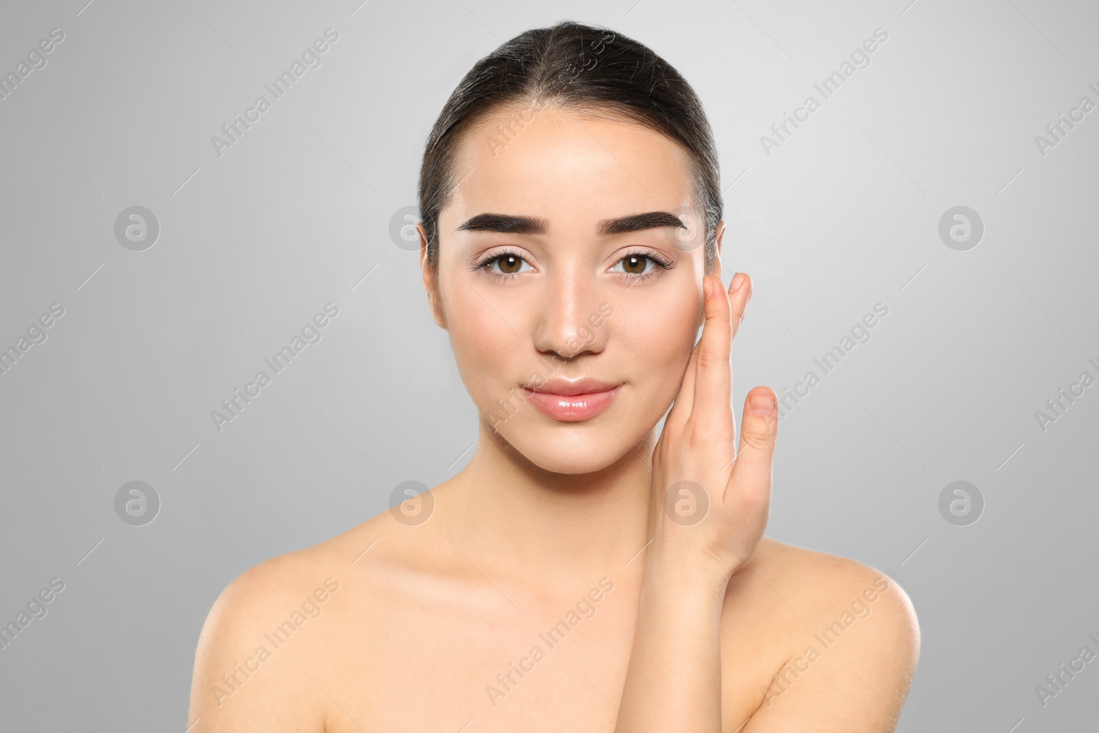 Photo of Portrait of young woman with beautiful face against color background