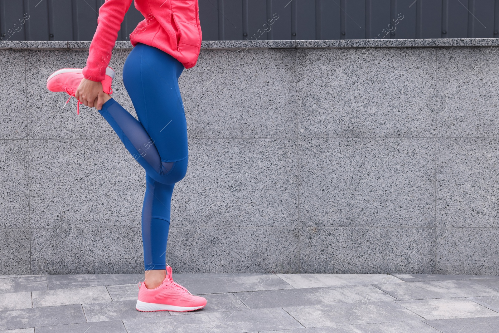 Photo of Woman in gym clothes doing exercises on street, closeup. Space for text