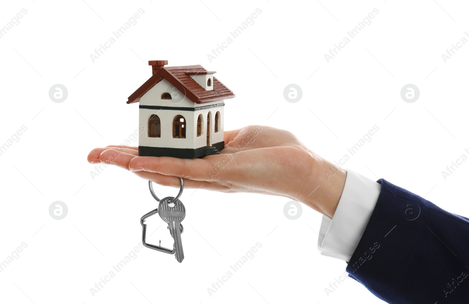 Photo of Real estate agent holding house model and key on white background, closeup