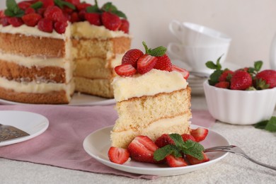 Piece of tasty cake with fresh strawberries and mint on white table