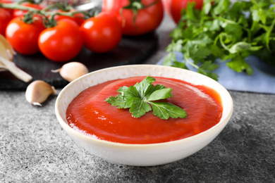 Photo of Delicious fresh tomato sauce on grey table, closeup