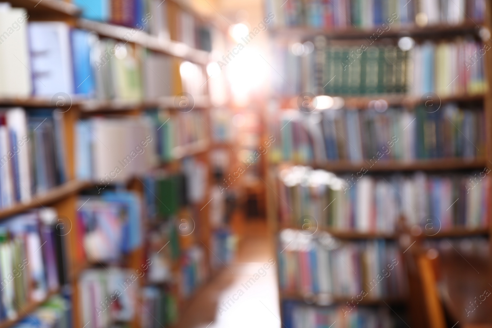 Photo of Blurred view of different books on shelves in library