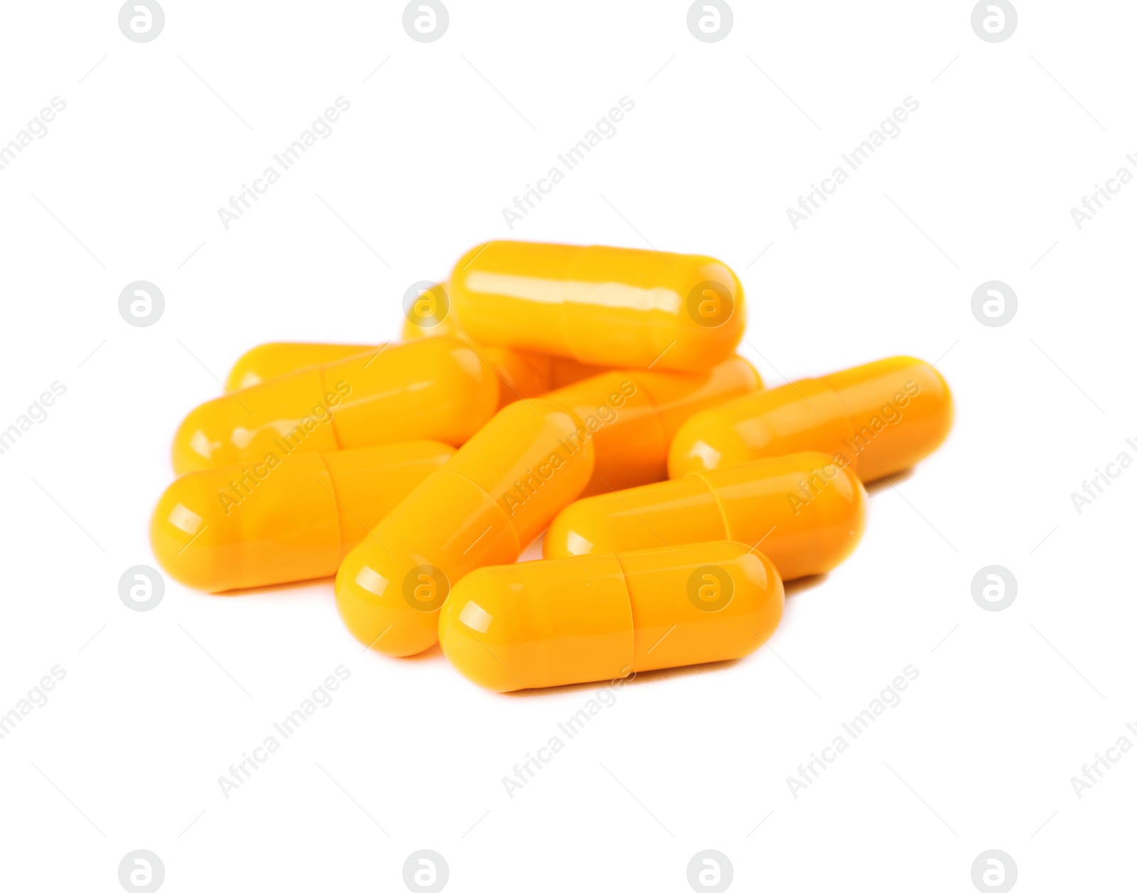 Photo of Pile of orange pills on white background