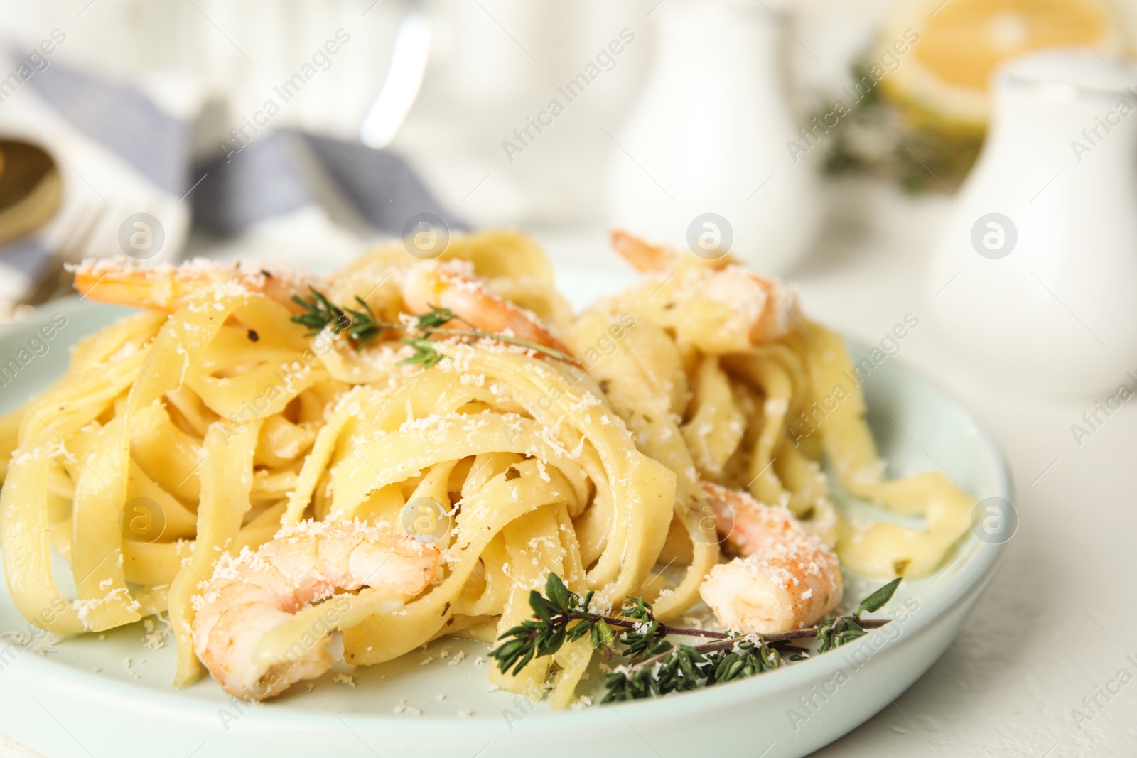 Photo of Delicious pasta with shrimps on white table, closeup