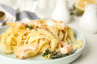 Delicious pasta with shrimps on white table, closeup