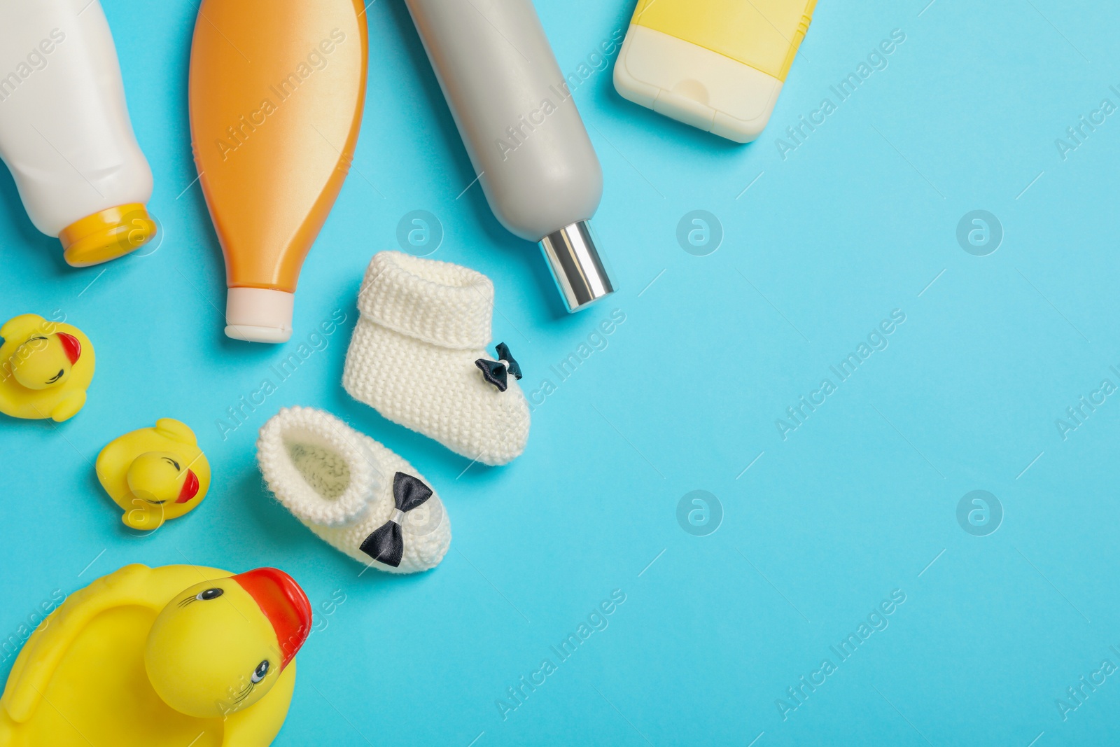 Photo of Flat lay composition with baby cosmetic products on light blue background, space for text